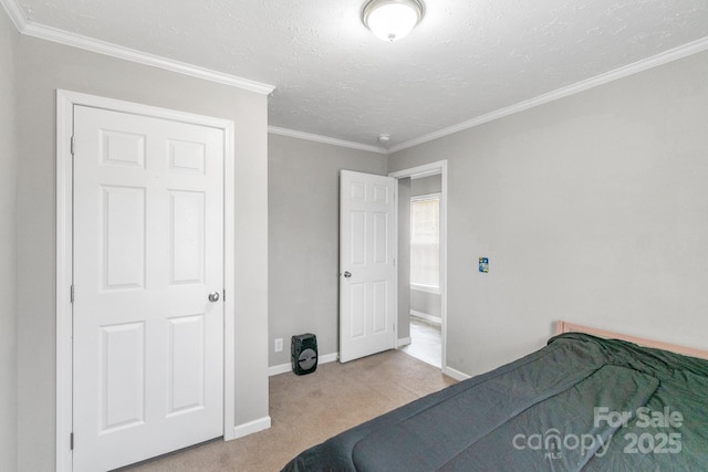 bedroom featuring ornamental molding, light carpet, and a textured ceiling