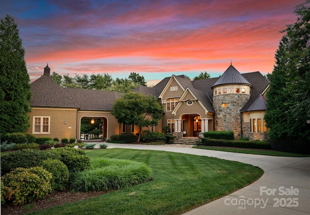 french country inspired facade featuring a lawn