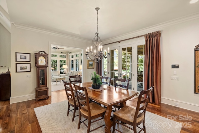 dining area featuring crown molding, ceiling fan with notable chandelier, dark hardwood / wood-style floors, and french doors