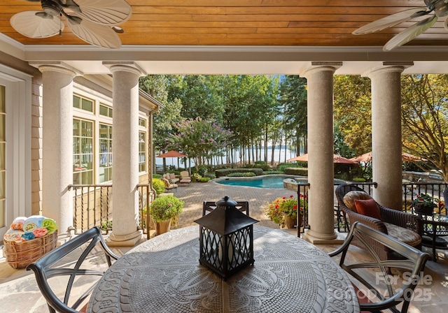 view of patio / terrace featuring a fenced in pool and ceiling fan