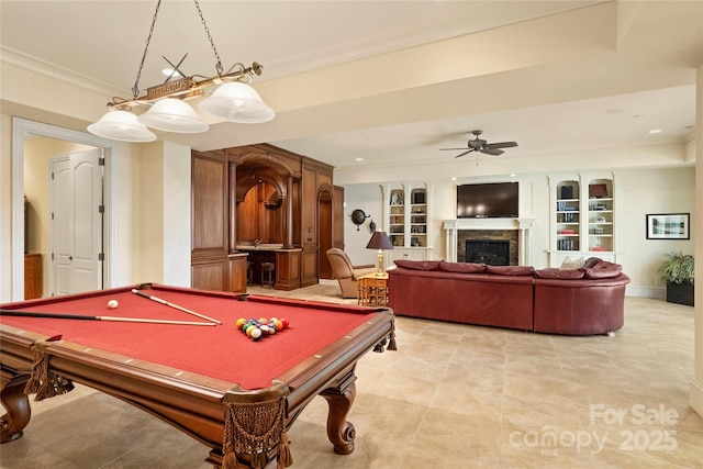 recreation room featuring ornamental molding, pool table, built in features, and ceiling fan