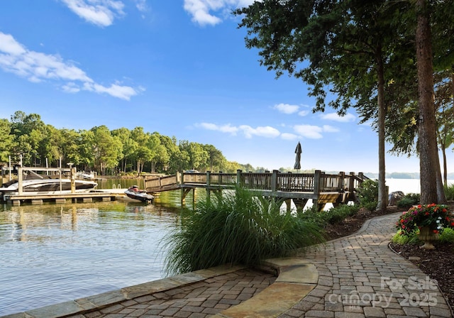 surrounding community featuring a dock and a water view