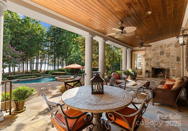 155 Union Chapel Dr, Mooresville, NC 28117 - view of patio / terrace featuring a pool with connected hot tub, an outdoor living space with a fireplace, ceiling fan, and outdoor dining area