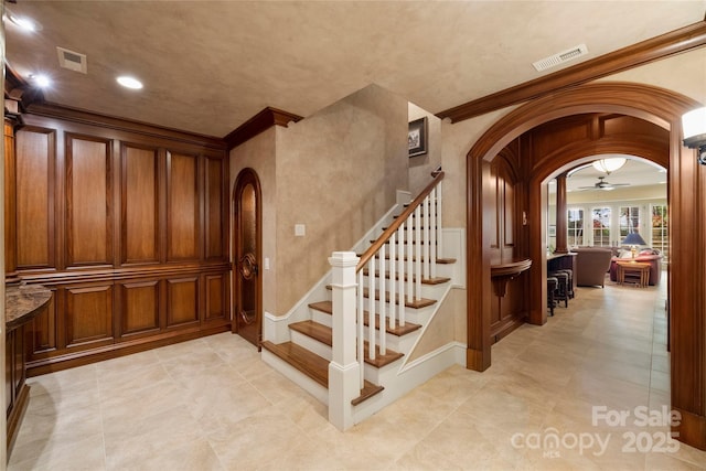 155 Union Chapel Dr, Mooresville, NC 28117 - stairway with arched walkways, crown molding, ceiling fan, recessed lighting, and tile patterned floors