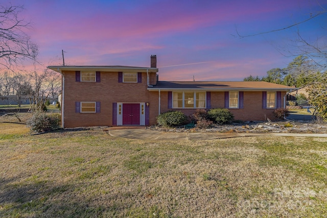 split level home with a lawn