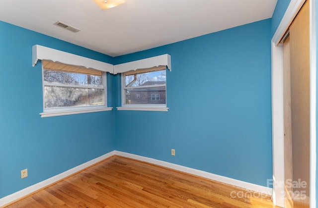 unfurnished bedroom with wood-type flooring and a closet