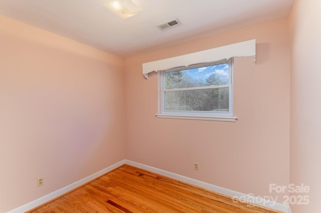 empty room with hardwood / wood-style flooring