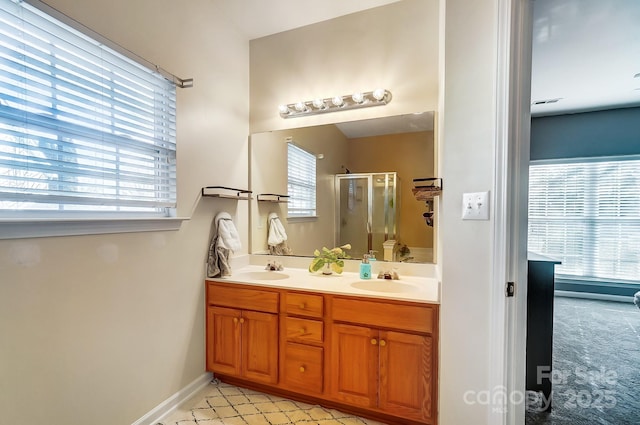 bathroom featuring an enclosed shower and vanity