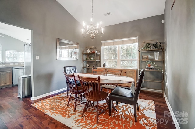 dining space with dark hardwood / wood-style flooring, a chandelier, and vaulted ceiling