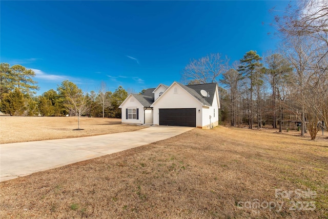 view of front of property with a garage and a front yard