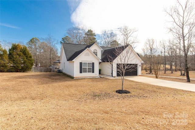 view of property with a garage and a front lawn