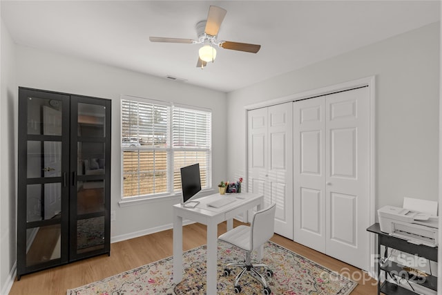 office area with light hardwood / wood-style floors and ceiling fan