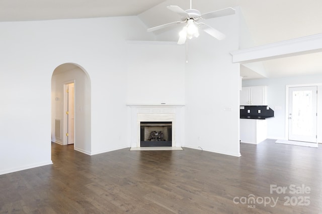 unfurnished living room with dark wood-type flooring, ceiling fan, lofted ceiling, and a premium fireplace