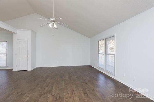 empty room featuring lofted ceiling, dark wood-type flooring, and ceiling fan