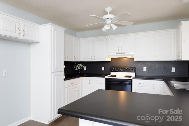 kitchen with electric stove, sink, dark wood-type flooring, white cabinetry, and kitchen peninsula