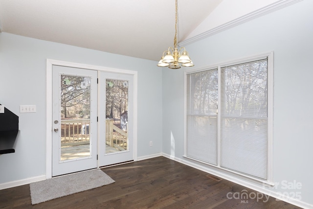 unfurnished dining area with lofted ceiling, a notable chandelier, and dark hardwood / wood-style flooring