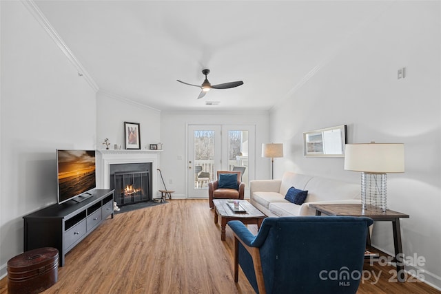 living room featuring ornamental molding, hardwood / wood-style floors, and ceiling fan