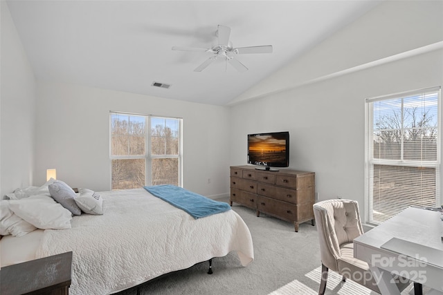 carpeted bedroom with vaulted ceiling and ceiling fan