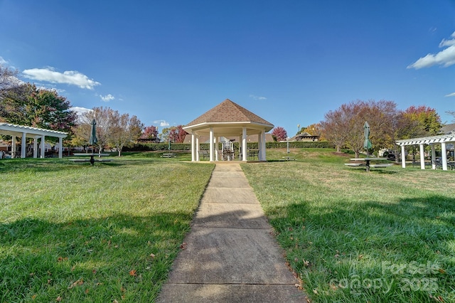 surrounding community with a gazebo, a lawn, and a pergola