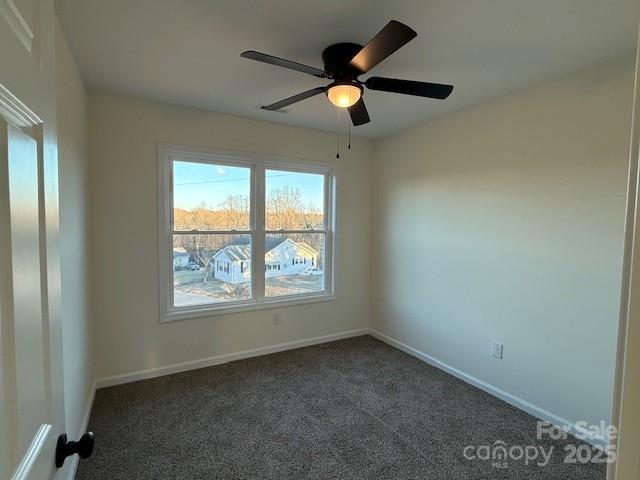 carpeted empty room featuring ceiling fan