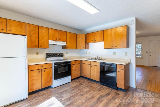 kitchen featuring sink, electric range, white refrigerator, dishwasher, and hardwood / wood-style floors