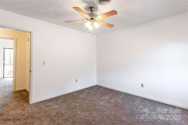 carpeted empty room featuring ceiling fan and a textured ceiling