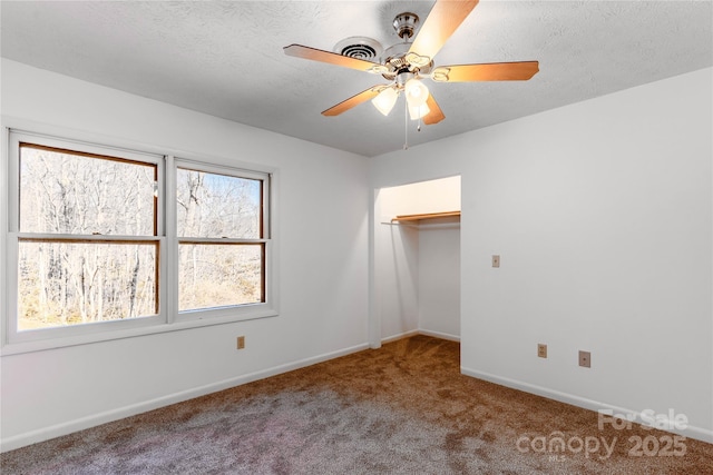 unfurnished bedroom with ceiling fan, carpet flooring, and a textured ceiling