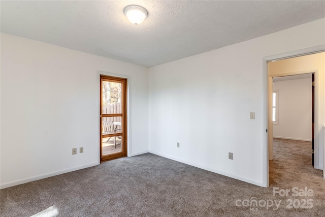 empty room featuring carpet flooring and a textured ceiling