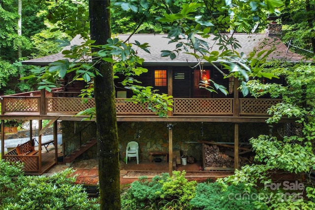 back of house featuring a wooden deck