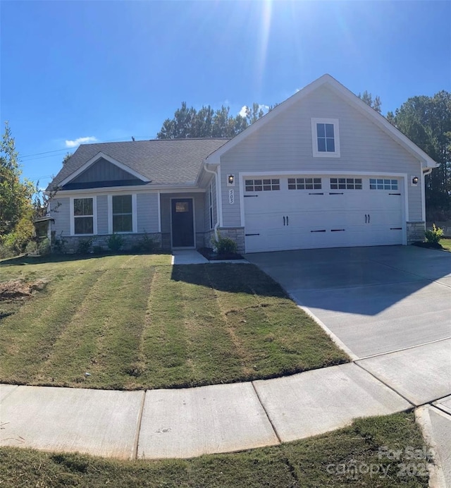 ranch-style home featuring a garage and a front yard