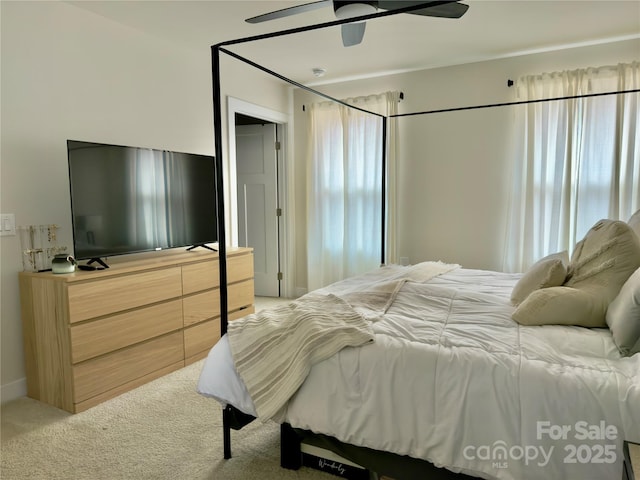 bedroom with ceiling fan and light colored carpet