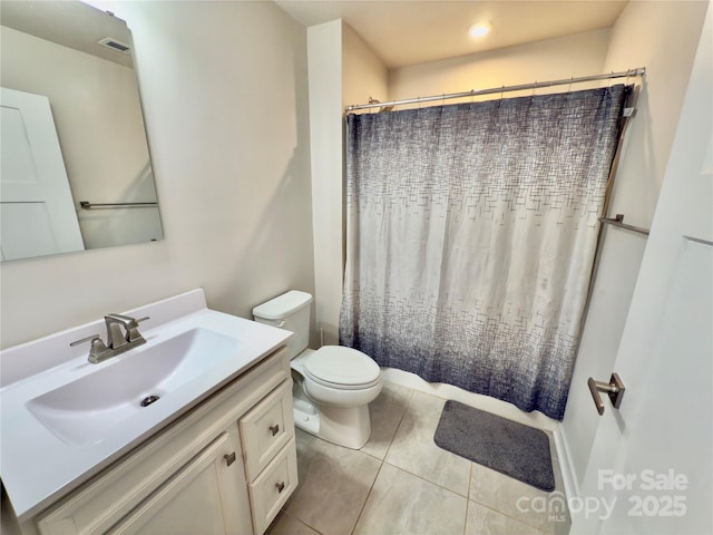 bathroom featuring a shower with curtain, vanity, tile patterned flooring, and toilet