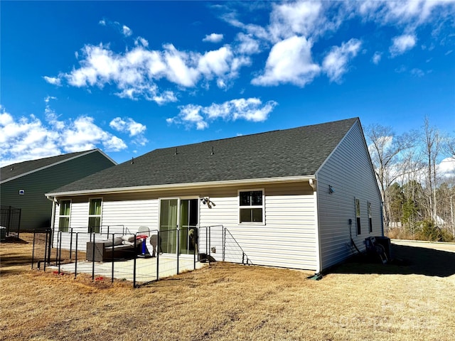 back of property featuring a yard and a patio