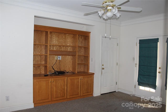 interior space with ornamental molding, ceiling fan, and dark colored carpet