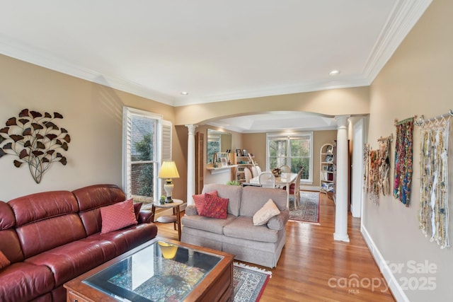 living room featuring crown molding, light hardwood / wood-style flooring, and decorative columns