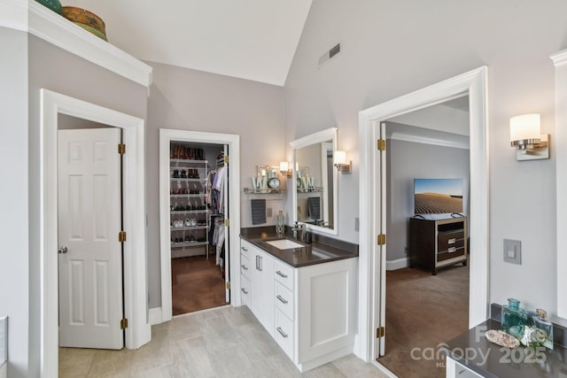 bathroom with lofted ceiling and vanity