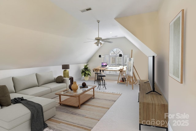 carpeted living room featuring ceiling fan and vaulted ceiling