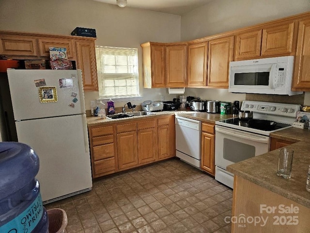 kitchen featuring white appliances and sink