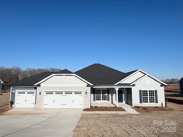 single story home with a garage and concrete driveway