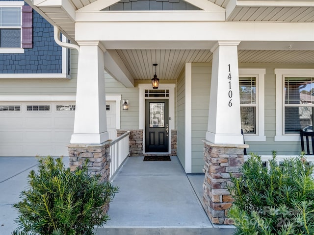 property entrance featuring stone siding, board and batten siding, and covered porch