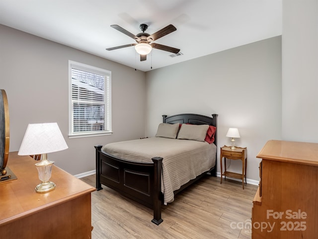 bedroom with visible vents, baseboards, light wood-style floors, and a ceiling fan