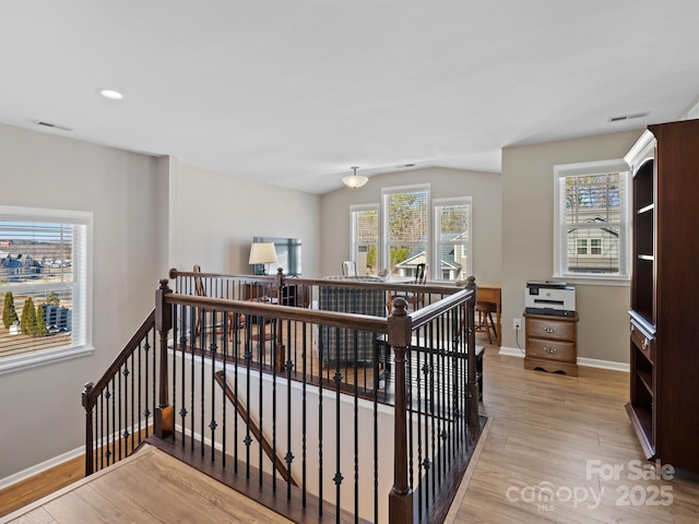 stairway with recessed lighting, wood finished floors, visible vents, and baseboards