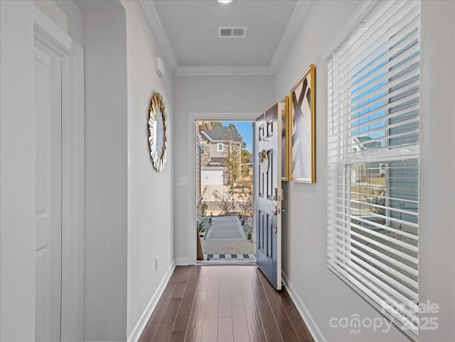 doorway to outside with crown molding and dark hardwood / wood-style floors