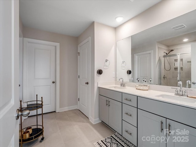 bathroom with tile patterned flooring, vanity, and an enclosed shower