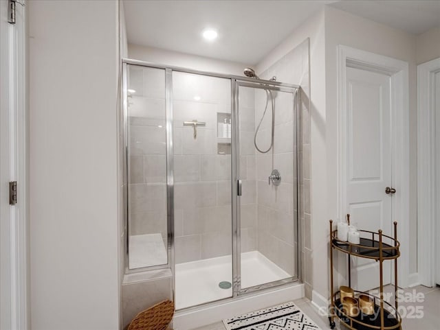 bathroom featuring a shower with shower door