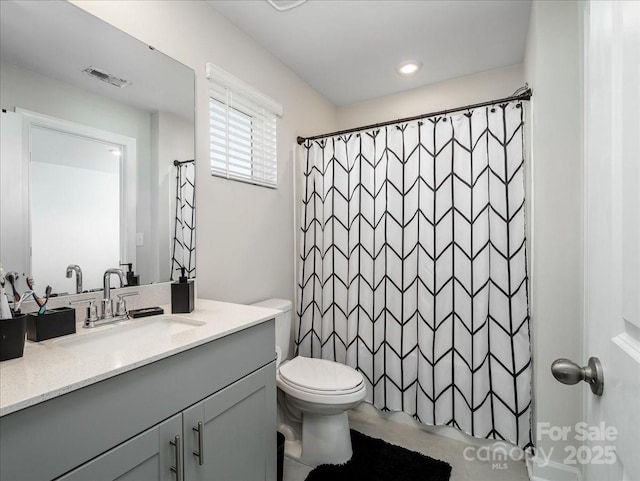 bathroom with vanity, curtained shower, and toilet