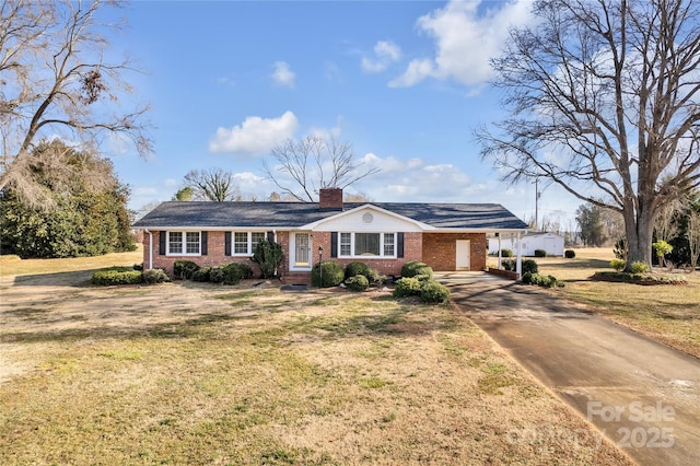 ranch-style home featuring a carport and a front yard