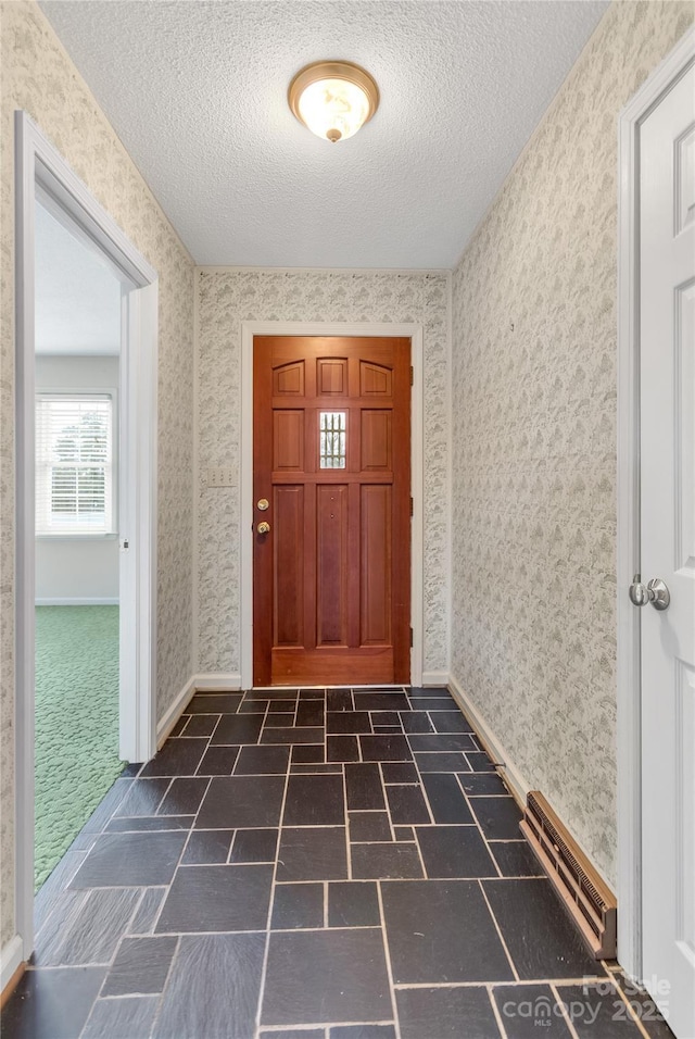 entryway featuring a textured ceiling