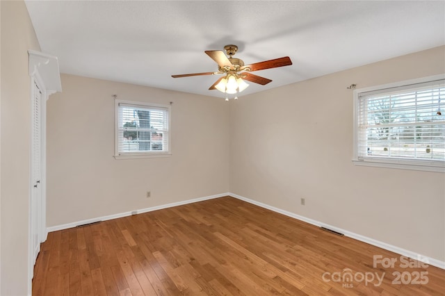 unfurnished room featuring hardwood / wood-style flooring and ceiling fan