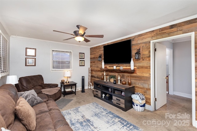 living room with ceiling fan, light colored carpet, ornamental molding, and wooden walls